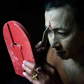 Brojen Yambem getting ready for performing rituals during Lai Haraoba at Loklaobung, Imphal. Unlike the amaibas, who are male priests, the position of amaibis are not determined by gender. The amaibi identity comprises both male (nupa) and female (nupi) amaibis. 