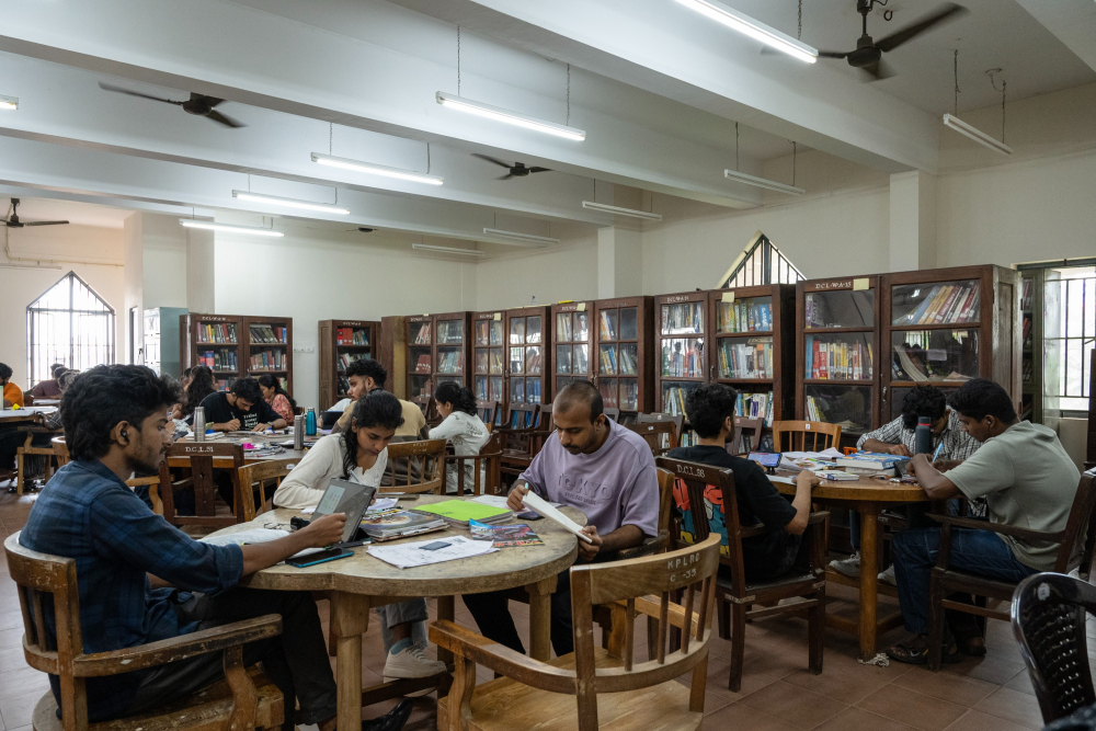 People reading inside the Kozhikode Public Library & Research Centre.