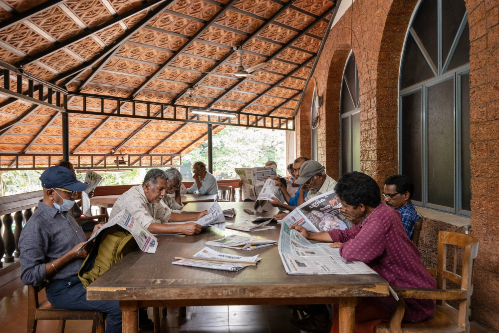 People reading newspapers at the Kozhikode Public Library & Research Centre.