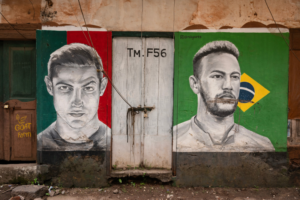 Graffiti featuring football players Cristiano Ronaldo and Neymar Junior on the walls of Gujarat Street.    Photo by Joseph Rahul.