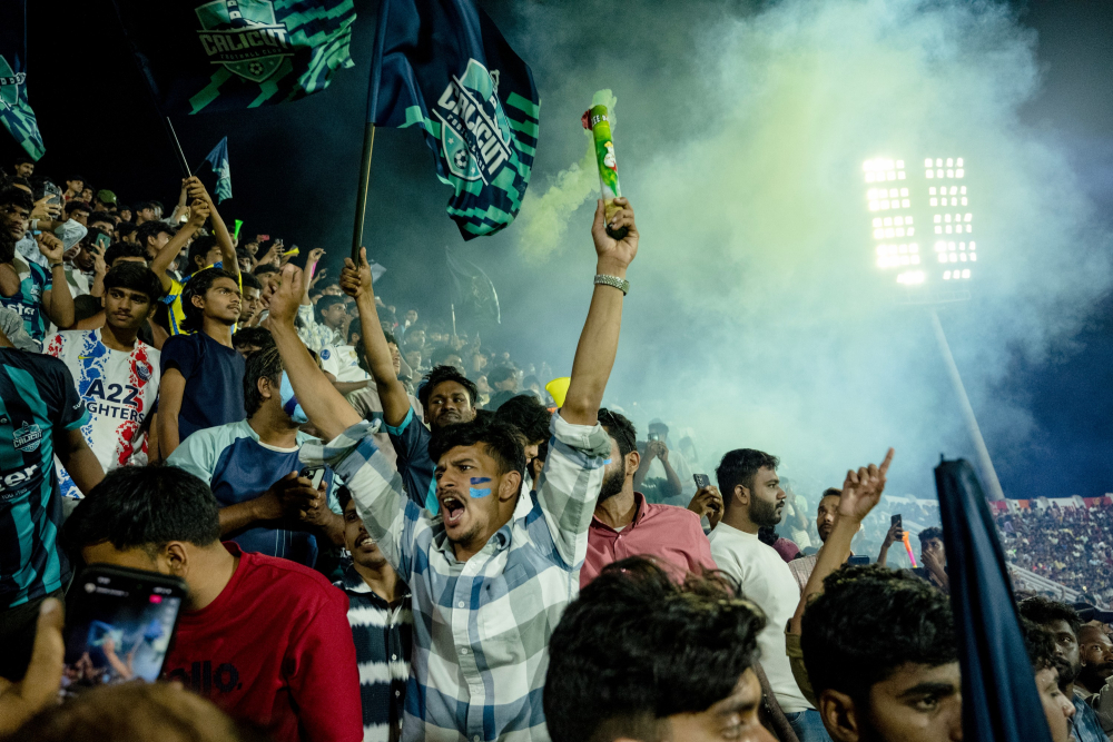 Calicut FC fans celebrating a goal.