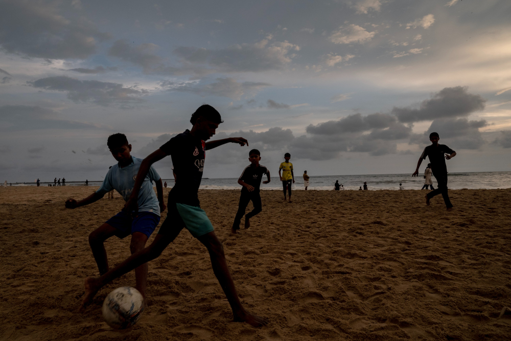 People playing football on Kozhikode beach.    Photo by Joseph Rahul.